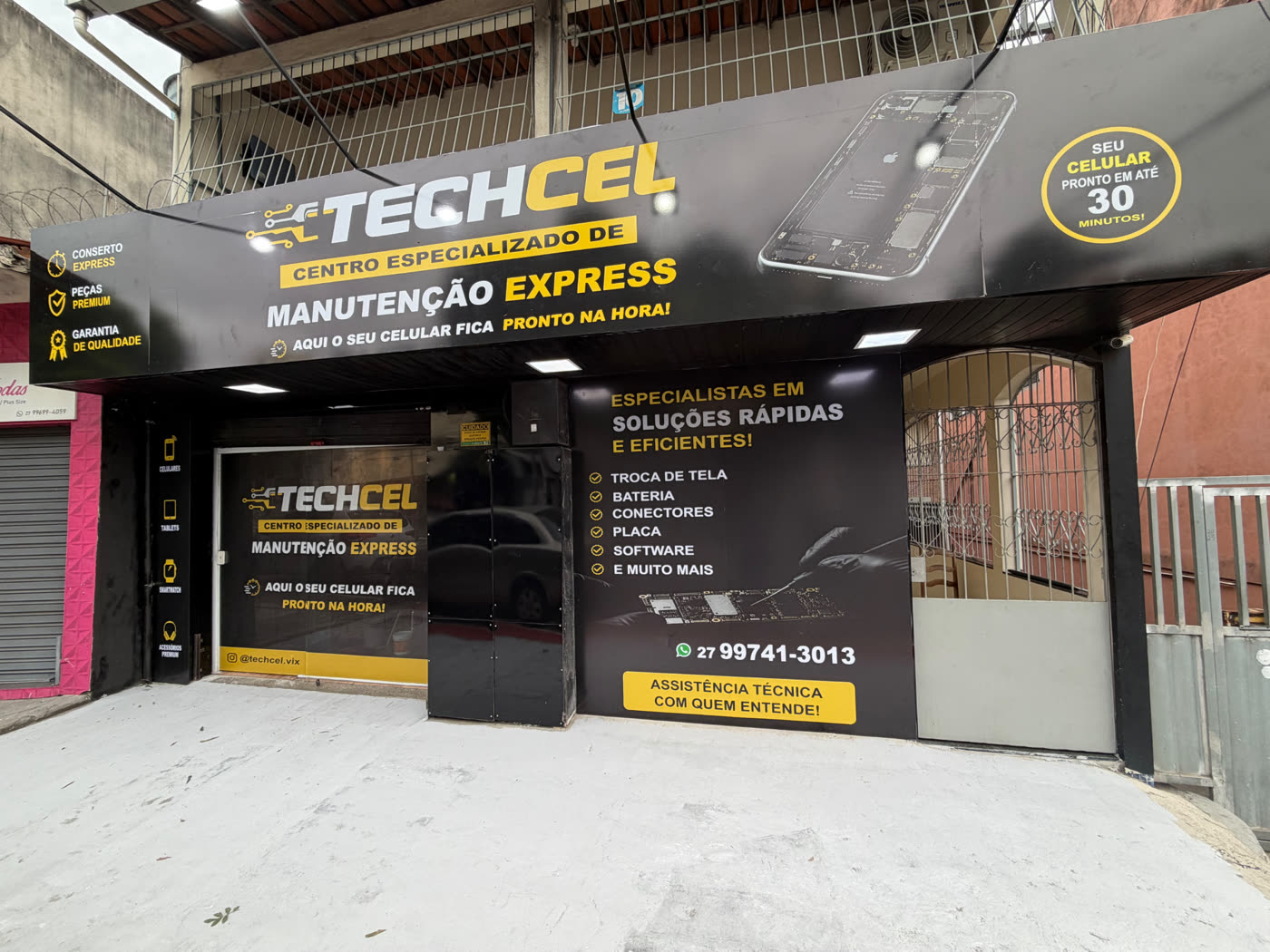 Fachada da loja TECHCEL em Vitória - ES durante o dia, com painel preto e amarelo